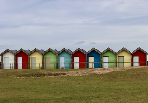 Line of colourful wooden beach huts