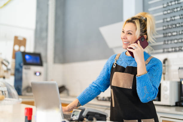 istock Coffee Shop Business Owner Talking on Phone at Work 1467868135