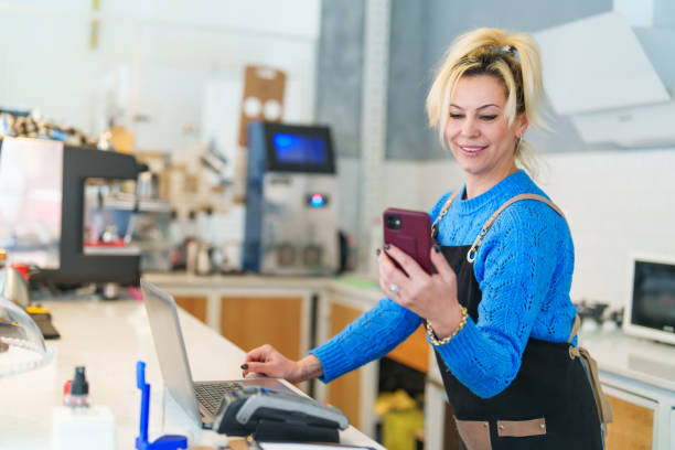 istock Coffee Shop Business Owner using mobile phone at work 1467868842