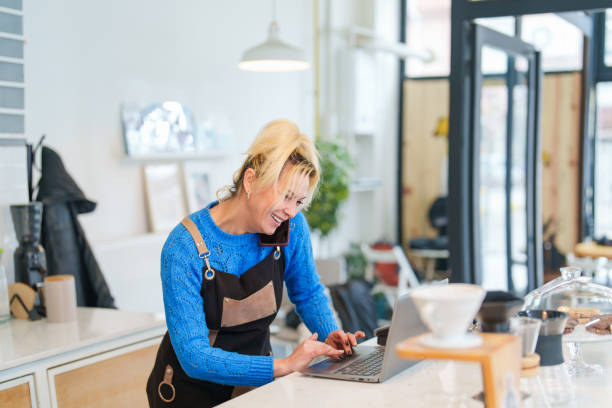 istock Coffee Shop Business Owner Talking on Phone at Work 1467869194