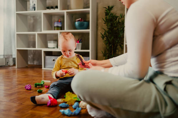 istock Mother and son molding a clay at home and having educational act 1467869254