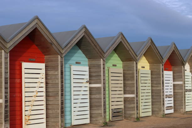 istock Line of colourful wooden beach huts 1467869929