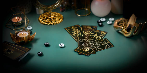 Defocused still Life with tarot cards. magic or fortune telling rite with occult and esoteric symbols.