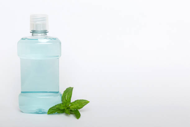 istock Mouthwash and fresh mint on colored background, top view with copy space for text 1467870986