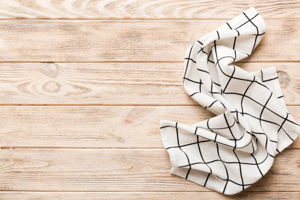 istock top view with white empty kitchen napkin isolated on table background. Folded cloth for mockup with copy space, Flat lay. Minimal style 1467871008