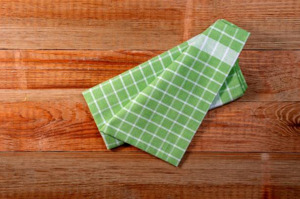 istock Colorful checkered kitchen cloth on wooden background 1467873847