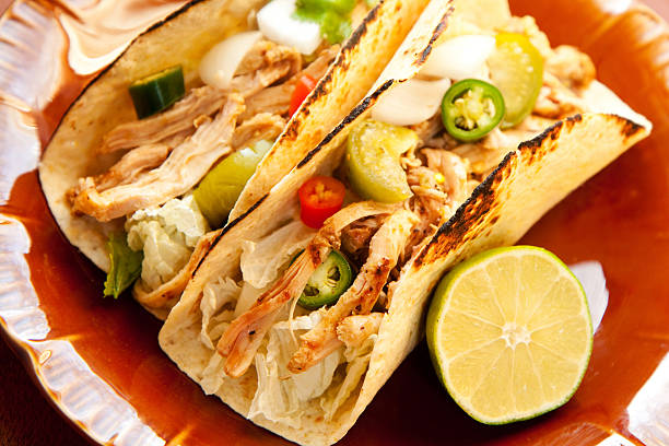 istock Plate of chicken tacos with half a lime 146787888