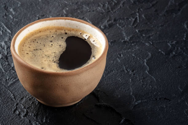 istock Coffee cup. Espresso in a simple brown mug on a black slate background 1467880074
