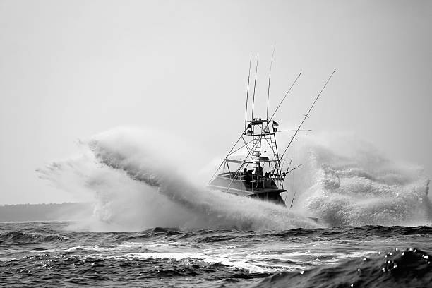 Sport Fishing Boat Crashing Through Waves Million dollar luxury fishing boat crashing through the ocean off the coast of South Carolina. big game fishing stock pictures, royalty-free photos & images