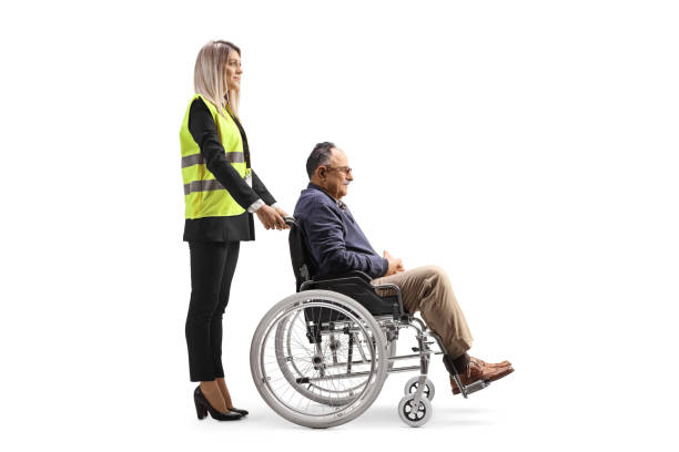 istock Female special assitance worker standing with a marture man in a wheelchair 1467884009
