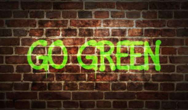 istock Go green spray painted inscription on the brick wall 1467884026