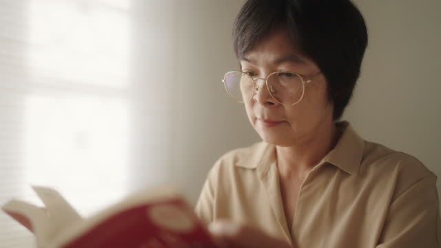 Mature woman reading a book.