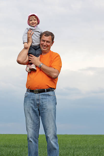 Little girl with grandfather stock photo