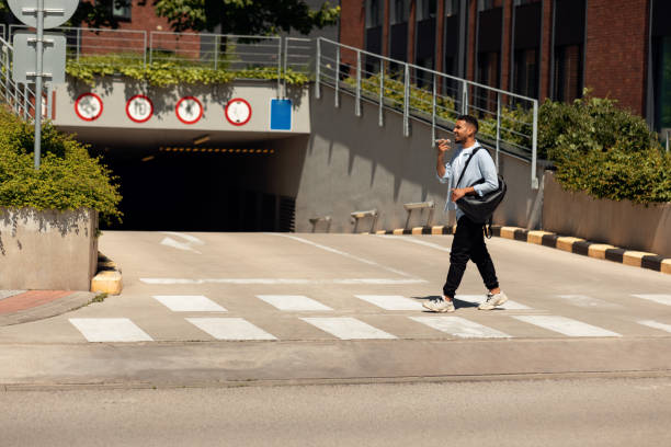 istock Smiling black man talking on phone walking in the city 1467886264