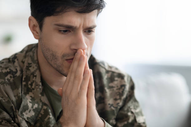 istock Serious young man soldier having thoughts of suicide 1467886631
