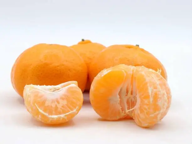 Closeup of mandarins peeled and isolated on white background