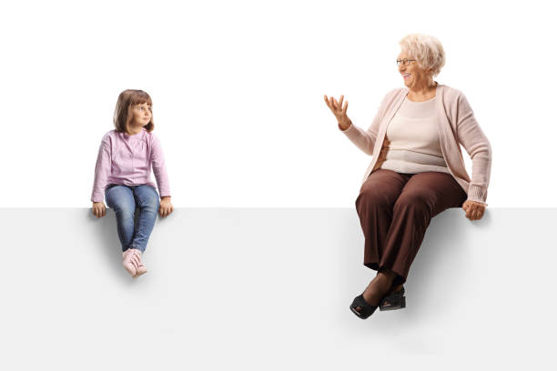 istock Child sitting on a blank panel and listening to grandma talking 1467887213