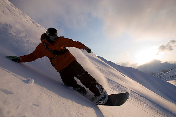 istock Snowboarder rides at sunset 146788776