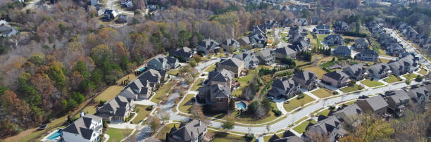istock Panorama view row of new developments houses in master planned subdivision with lush green trees and natural trails outside Atlanta, Georgia, US 1467889046