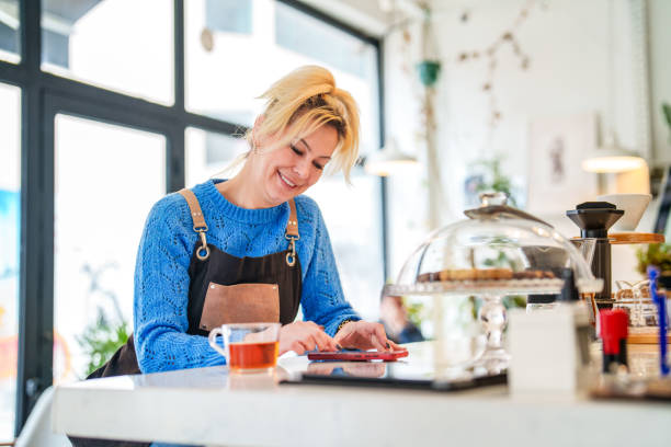 istock Coffee Shop Business Owner using mobile devices at break 1467889164