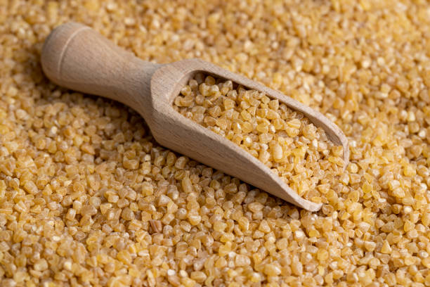 istock Not cooked wheat porridge with a wooden spoon 1467889453