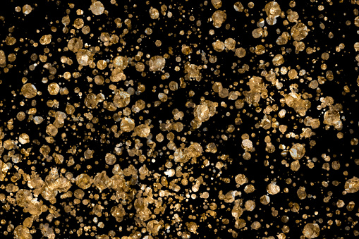 golden nuggets texture black background full frame