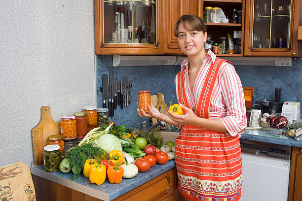 Girl with vegetables and jars Girl with vegetables and jars in the kitchen pattyson stock pictures, royalty-free photos & images