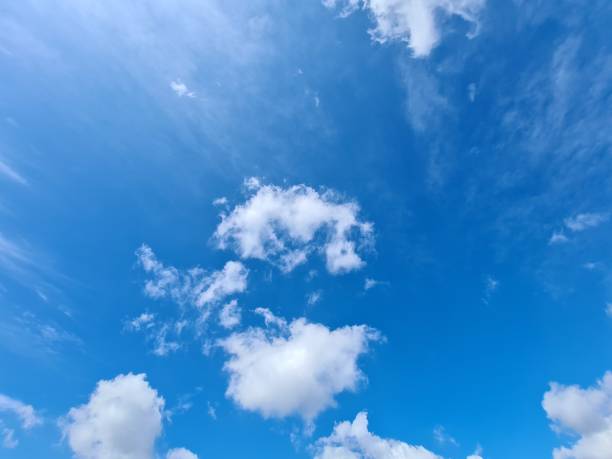 close up of white clouds against a bright blue sky background