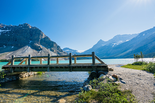 Banff National Park beautiful landscape. Bow Lake lakeshore trail and wooden bridge. Alberta, Canada. Canadian Rockies nature scenery.