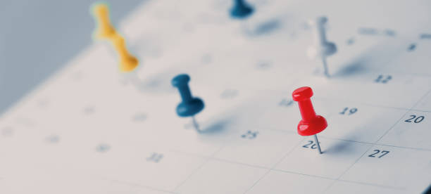 istock Embroidered red pins on a calendar event Planner calendar,clock to set timetable organize schedule,planning for business meeting or travel planning concept. 1467893670