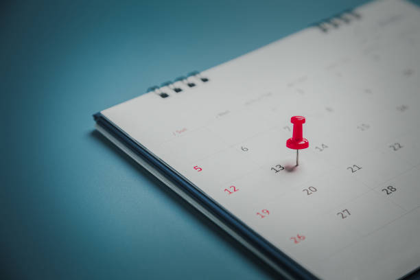 embroidered red pins on a calendar event planner calendar,clock to set timetable organize schedule,planning for business meeting or travel planning concept. - calendar calendar date reminder thumbtack imagens e fotografias de stock