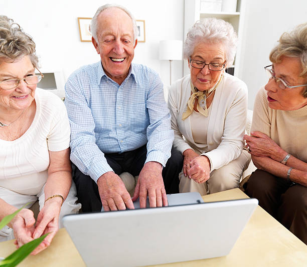 istock Happy senior men and women using laptop 146789382