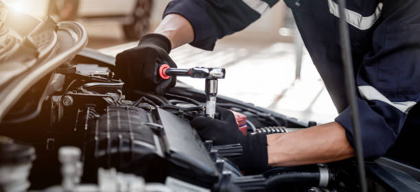 istock Car care maintenance and servicing, Close-up hand technician auto mechanic using the wrench to repairing change spare part car engine problem and insurance service support. 1467894567