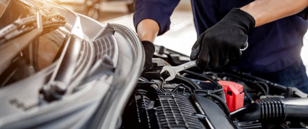 istock Car care maintenance and servicing, Close-up hand technician auto mechanic using the wrench to repairing change spare part car engine problem and insurance service support. 1467894577