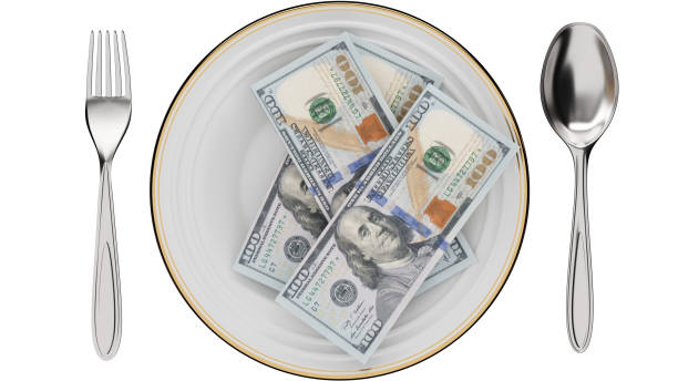 istock Money in dinner plate with Fork and spoon isolated on white background with clipping path. Restaurant, food, cost, economy concept 1467894769