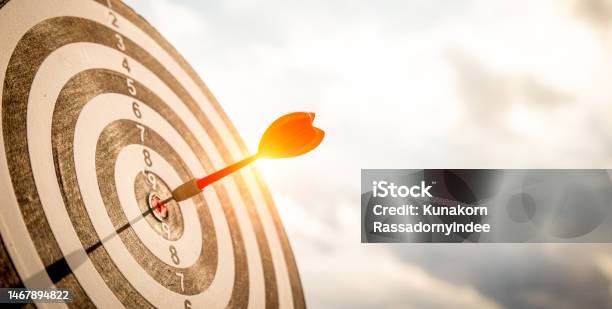 Close Up Shot Red Darts Arrows In The Target Of Dartboard Center On Dark Blue Sky Background Business Target Or Goal Success And Winner Concept Stock Photo - Download Image Now