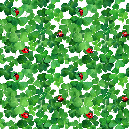 Watercolor drawn clover leaves and ladybugs in seamless pattern. Botany wallpaper with green grass and red bugs. Saint Patrick day background. Design for covers, packaging, fabric.