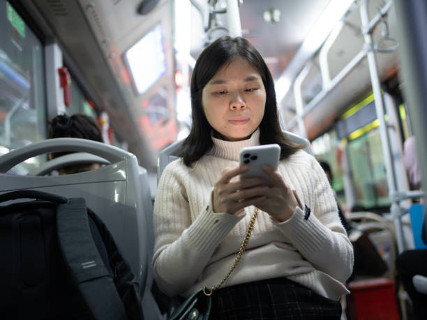 istock woman looking at mobile phone during get off work 1467895788
