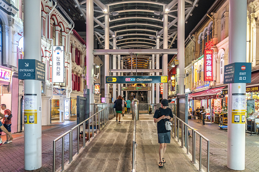 Singapore, Singapore - February 12, 2023: Commuters are walking inside the Chinatown MRT station,