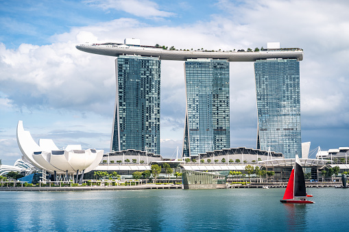 Singapore, February 11, 2023. View of the famous landmark, Marina Bay Sands in Singapore seen a sunny day. The hotel is shaped like a boat with a large infinity pool on the roof.
