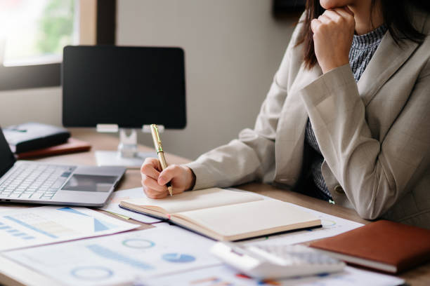 istock businessman hand working with new modern computer and writing on the notepad strategy diagram as concept morning light 1467897885