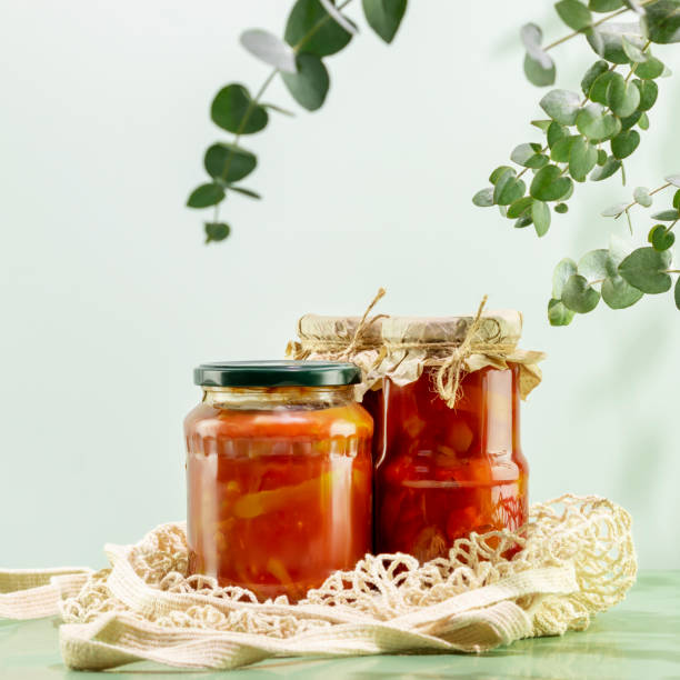 istock Fermented vegetables in glass jars on mesh bag on blue background 1467897967