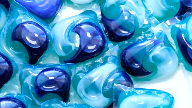 Background of colorful capsules with washing powder for washing dishes of the dishwasher