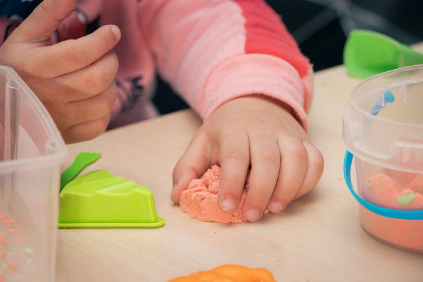 istock girl playing with magic sand, making handicrafts 1467899098