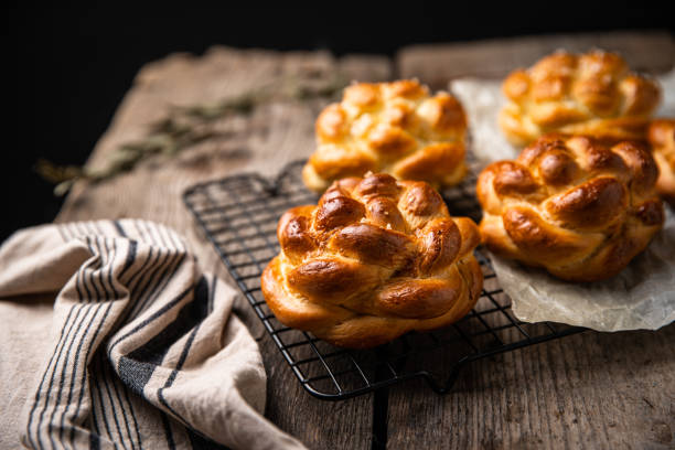 istock Fresh braided brioche buns on wooden table. 1467900466