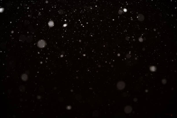 istock Snowfall isolated on black background. Abstract white bokeh background. 1467900561