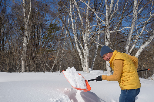Senior man removing snow