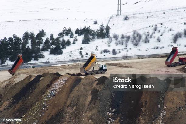 Excavation Site And Trucks In Winter Stock Photo - Download Image Now - Backhoe, Building - Activity, Bulldozer