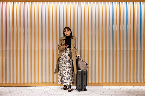 Asian businesswoman waiting in airport terminal