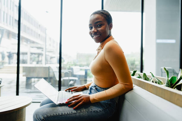 istock African female student working on computer in public place 1467903389